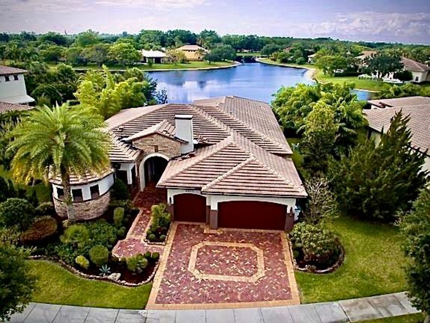One story 5 bedroom, 3 bath estate home with fully fenced yard over looking a magnificent 3 point water view. Large kitchen with wood cabinets, granite, impact windows and doors throughout, crown molding, marble floors, built ins, 3 way split. Beautifully landscaped and a private backyard. Enjoy the tropical breeze on the oversized patio and pool area.  3 car garage, sprinkler system off the lake and so much more.  Enjoy all that Parkland Golf and Country club offers.