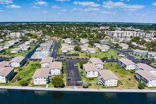 A LARGE 1 BEDROOM DELUXE CORNER UNIT! and 1/2 BATH , A VERY SPECIAL LOCATION !!!SEE The BOATS GO BY FROM YOUR DINING ROOM WINDOW, STRAIGT AWAY VIEWS, ACCROSS FROM THE CLUBHOUSE AND COMMUNITY POOL . LIGHT AND BRIGHT, REMODELED THROUGHOUT, REFINISHED CEILINGS, NEW KITCHEN CABINETS, NEW TILE THROUGHOUT , PLANTATION SHUTTERS, ON ALL WINDOWS, ACCORDION SHUTTERS ON ALL EXTERIOR WINDOWS, A MUST SEE IN STERLING VILLAGE INTRACOASTAL LIVING, AND WALK TO THE BEACH !!!!