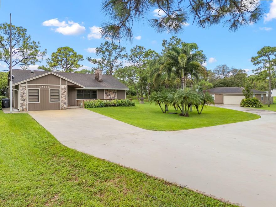 Welcome to this charming 3-bedroom, 2-bathroom home nestled on 1.29 acres in the heart of Loxahatchee. Built in 1990, this single-story home offers nearly 1,400 sq. ft. of living space with a split-bedroom layout, vaulted ceilings, and an inviting floor plan. Large detached garage that is 1,057 sq ft (fits up to 4 cars). The kitchen is equipped with all stainless steel appliances and opens to spacious living and dining areas, perfect for gatherings and everyday living. The primary suite includes ample closet space and a private bath, while the additional bedrooms provide comfort and flexibility for family or guests. Step outside and enjoy your private Florida oasis featuring a sparkling screened pool, large patio, and plenty of yard space with canal frontage for added views and privacy.