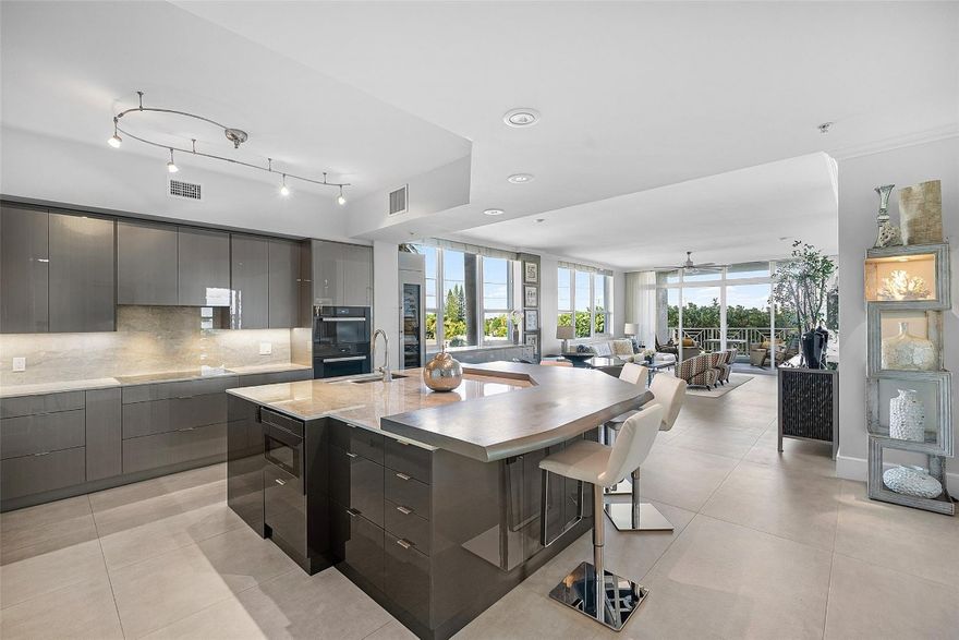 SOPHISTICATED BEACHSIDE RESIDENCE. Thoughtfully fully furnished corner 3BR/3BA with ocean views from two private balconies—perfect for sunrise coffee and evening breezes. Sunlit wrap-around windows enhance an open layout with 5' porcelain tile, 10' ceilings, and high-impact glass. The chef’s kitchen features $40K+ in upgrades: Miele double ovens, induction cooktop, three Sub-Zero refrigerators including wine cooler, Dekton surfaces, and a large island. The primary suite offers dual walk-ins and a spa-like marble bath. Two stylish guest suites, full laundry room, two garage spaces, and climate-controlled storage. Resort amenities include heated pool, hot tub, fitness center, steam room, sauna, BBQ areas, and EV charging. Steps to upscale dining, boutique shopping, and the iconic DFB Pier.