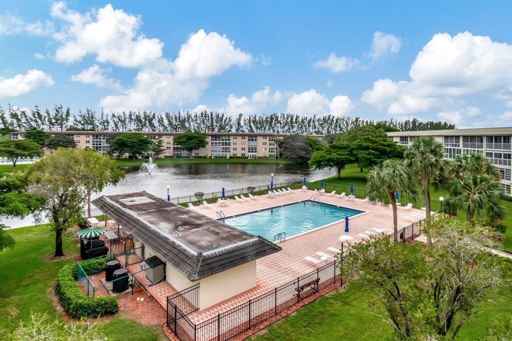 Fantastic LAKE/POOL VIEW from this Large IRIS MODEL with WASHER/DRYER Inside Plus HURRICANE SHUTTERS THRU-OUT and GLASS ENCLOSED PATIO. Built-In Desk in the Guest Bedroom Plus TURN-KEY FURNISHINGS INCLUDED Except the Piano which is Negotiable. ASSOCIATION REQUIRES ONE OCCUPANT 55+ WITH 15% DOWN AND WYNMOOR INCOME FORMULA AND A CREDIT SCORE OF 700 PLUS $250 REFUNDABLE MOVE-IN FEE. Information Deemed Reliable but, Not Guaranteed.