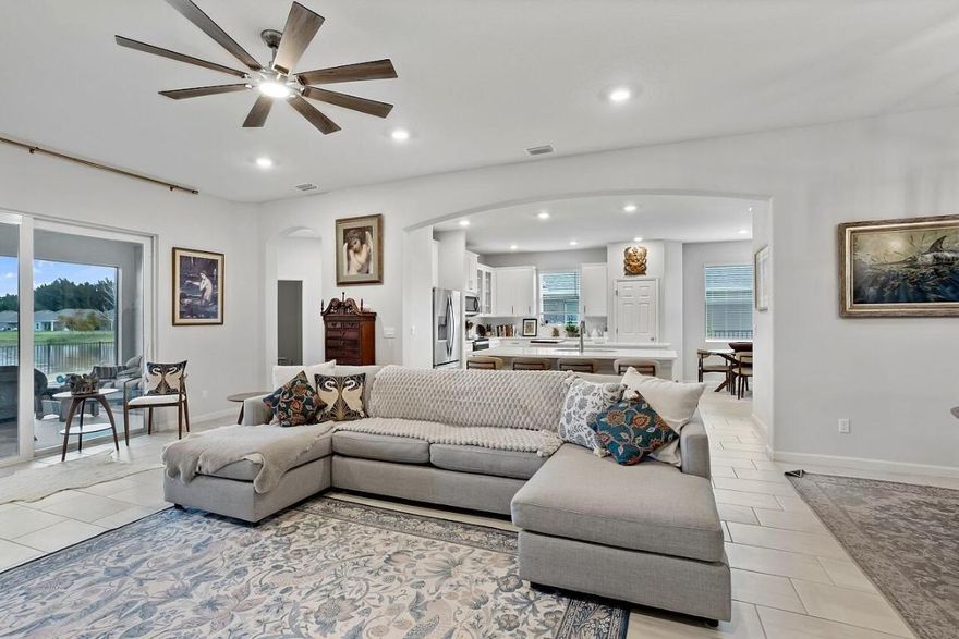 Better than new! Built in 2023 with $30,000+ in upgrades, this 3BR/3BA home with a 3-car garage features impact windows and doors throughout. Enjoy a screened epoxy patio overlooking a fenced yard with lake and fountain views (plenty of room for a pool). The kitchen offers double islands, quartz countertops, stainless appliances, pantry, and breakfast nook. The primary suite stuns with a tray ceiling and two custom walk-in closets. Additional upgrades include epoxy garage floor, gutters, screened front porch, and quartz bath vanities. Gated community, low HOA, central location—don't miss it!