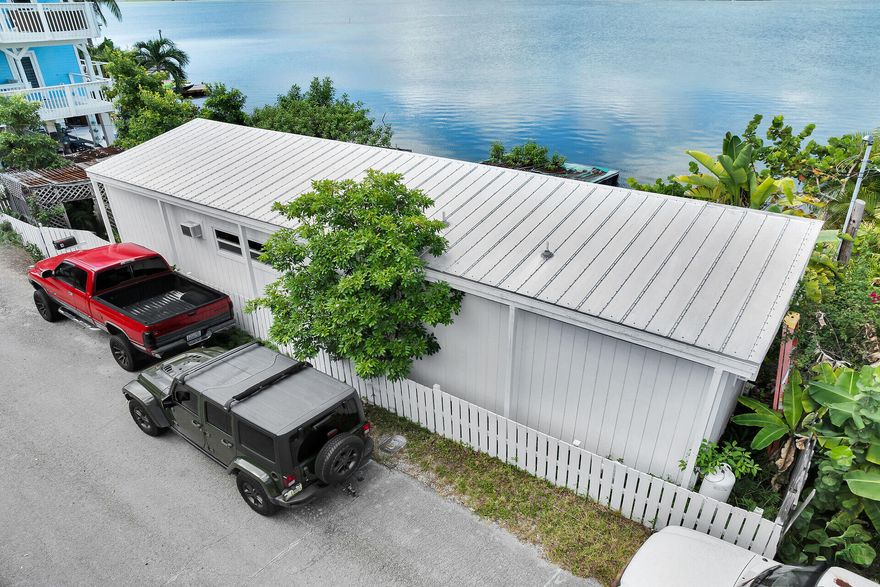 Million dollar views! Ocean and Gulf views make this an affordable waterfront gem. Situated in the quiet and peaceful Bay Point neighborhood, this home is only 17 miles from Key West allowing quick city access and return to waterfront bliss.  This Keys-style fish camp offers a waterfront manufactured home with 2 bedrooms and 2 baths. The side yard is a leafy oasis or reconfigured for parking.   Enjoy easy living on 62' of ocean front with spectacular sunset views!