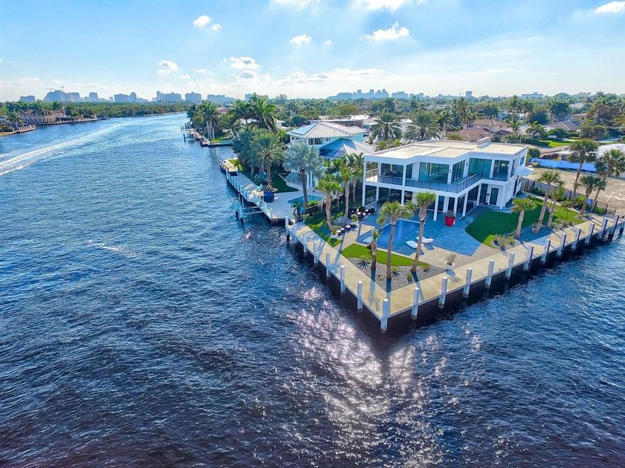 Welcome to one of the most incredible new waterfront homes South Florida has to offer. This masterpiece was built on a 12488 sq. ft. point lot, with over 190 feet of water frontage on the Intracoastal water way. Crafted with extreme detail and the highest end finishes, this home has stunning water views from every room. This concrete/steel construction was professionally designed beyond any expectation. 
The lot boasts 65 feet on the ICW, and 125 feet on the canal, allowing a 105 foot long yacht or multiple boats without interfering with your view. The double glass door foyer opens to soaring 22 ft tall ceilings. The spectacular chef's kitchen boasts a Viking professional package with 8 gas burner stove, an expansive 15-foot Island, Lapitec countertops, and black matte finger print proof cabinets with led lights. 
The floors are graced with 72"X32" Italian porcelain throughout, and are extended out to the upper and lower wrap around balconies. The dramatic floating stairs are custom designed with 4" white oak and a modern glass railing.  There is a ground floor in law suite with a private entrance that boasts a gorgeous custom kitchen plus a stackable washer and dryer, offering complete privacy for guests. Step outside and enjoy the spacious covered area with a 32X12 pool plus hot tub, with custom led lighting package and zero scape landscaping. The long driveway frames the dramatic curb appeal of this home and can accommodate 8 cars. The 22 foot garage is 2 cars deep with two 9000 pound hydraulic lifts to accommodate 4 cars. The home is energy efficient with split AC control system in every room. This 2020 construction is built to the newest city regulations and the entire property has been elevated 28 inches above ground (X Zone), so no flood insurance is required. The TPO system over concrete roof provides very low home insurance. A brand new seawall and 8 ft concrete dock were also added.
Coral ridge is one of the safest neighborhoods in Ft Lauderdale with one of the best school systems. Schedule your private showing today.



The square footage of the Property has not been measured by Seller, Seller's agents, or Listingly (including square footage of the lot and home), and the square footage and other information quoted on any marketing tools such as advertisements, brochures, MLS data, websites and any other information provided based on information supplied by Seller or Listingly is deemed approximate and not guaranteed. 
Further, neither Seller or Listingly have made any independent investigations or verification of such information and make no representation as to the accuracy or completeness of such information. Buyer further acknowledge that Buyer shall not rely upon any such square footage and other information quoted on any marketing tools are not representations and/or warranties of Seller, Seller's agents, or Listingly.