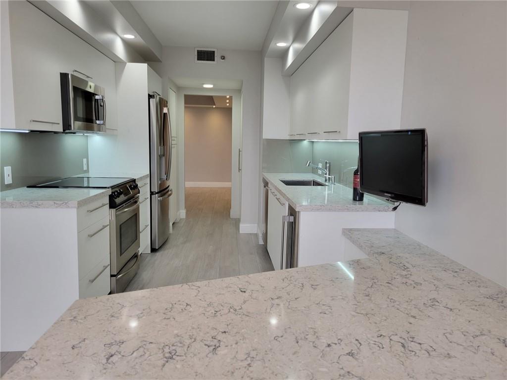 Available Sept 15, 2025 for annual lease. Unfurnished. Gorgeous completely renovated 2 bed/2 bath unit overlooking the golf course and pool area. Porcelain plank flooring throughout. Modern kitchen, wine cooler, granite counter tops. Lutron lighting dimmer throughout. Motorized window shades in living room. Hamptons West offer incredible amenities including fully equipped Health Club & Spa, indoor basketball & racquetball court. Tennis courts. Resort style swimming pools & 2 on site restaurants. Call today!