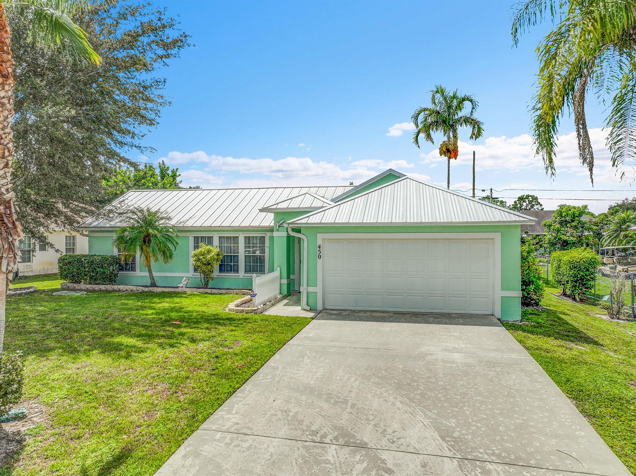 Welcome to this charming 3-bedroom, 2-bath, 2 car garage in highly desired Port St Lucie, Florida. This well-maintained property features a newer Metal roof, fence, water heater. Inside, enjoy the convenience of an indoor laundry room, tile flooring throughout, and vaulted ceilings that create an open, airy feel. Outside, the large fenced-in yard provides plenty of space for relaxation, play, or entertaining. With its practical layout and spacious dining area, this home offers comfort, functionality, and peace of mind in one of Port St Lucie's most sought-after areas.