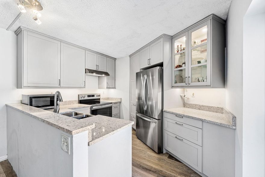 Discover your next home in the sought-after Somerset community, where tranquility meets modern elegance in this stunning two-bedroom, two-and-a-half-bathroom townhouse. This well-maintained residence offers 1,218 square feet of thoughtfully designed living space that perfectly balances comfort and style. Major upgrades provide both comfort and peace of mind, including a new A/C unit installed in 2021, impact windows, all the bathrooms, a new water heater, and a new front door, enhancing both efficiency and security. The heart of the home features a newly remodeled kitchen with an open-concept layout that flows seamlessly throughout the main living area. An impressive eat-in kitchen bar creates the perfect gathering space for family and guests.