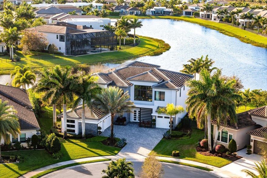 Formerly the Model Home for the Palermo Contemporary Model in Boca Bridges, this fully furnished, turn-key 5-bedroom, 6.1-bathroom estate sits on a .4-acre lot and is the pinnacle of luxury living. Situated on the most coveted pie-shaped lot, it offers breathtaking 180-degree water views with a tranquil fountain backdrop and spectacular western sunsets. Designed for both style and functionality, this home features two dedicated work-from-home offices, a club room, media room, loft, living room, family room, and a formal dining room. The gourmet kitchen boasts top-of-the-line Wolf and Sub-Zero appliances, Shelf Genie custom pull-out kitchen drawers, and a water filtration system--ideal for culinary enthusiasts. Expansive zero-entry sliders off the family room create a seamless indoor-