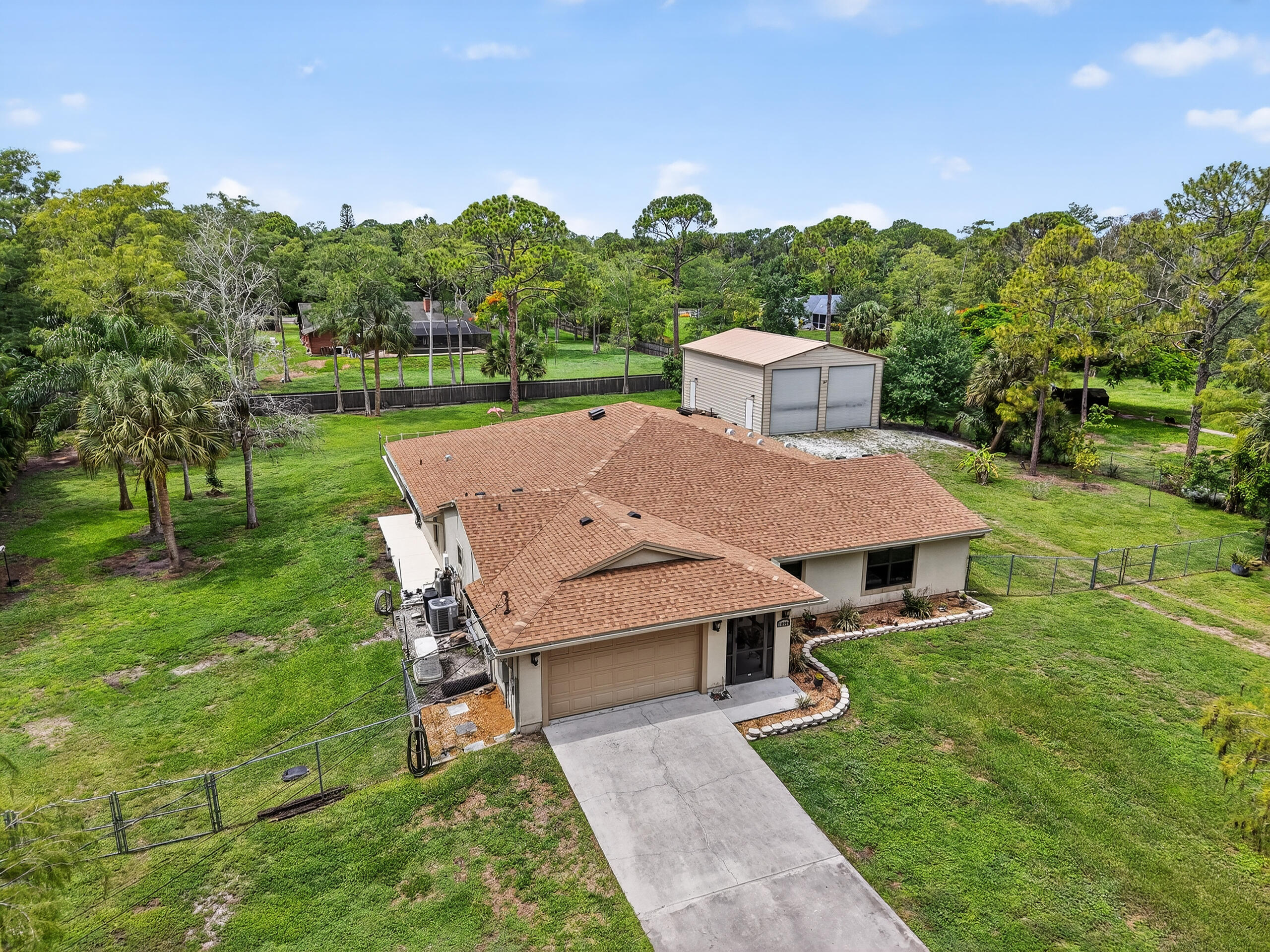 Beautiful family retreat in a tranquil country setting. This property sets on 1.41 acres where modern amenities meet country charm. This 5 BR residence features 2 master suites, 4 full baths + a versatile flex room.The expansive screened-in patio offers serene views of the lg property while the sparkling salt water pool/Jacuzzi invites you to relax & unwind. Inside,a gourmet kitchen boasts granite countertops, double ovens, a warming drawer, & a large island perfect for entertaining.Other highlights include an innovative safe room w/reinforced concrete walls & hurricane door, whole house impact windows and generator & solar roof fans for optimal attic cooling. A massive (30x40x16) 2ndary bldg, fully air-conditioned & insulated is perfect for housing boats or RVs. +Greenhouse & chickencoop