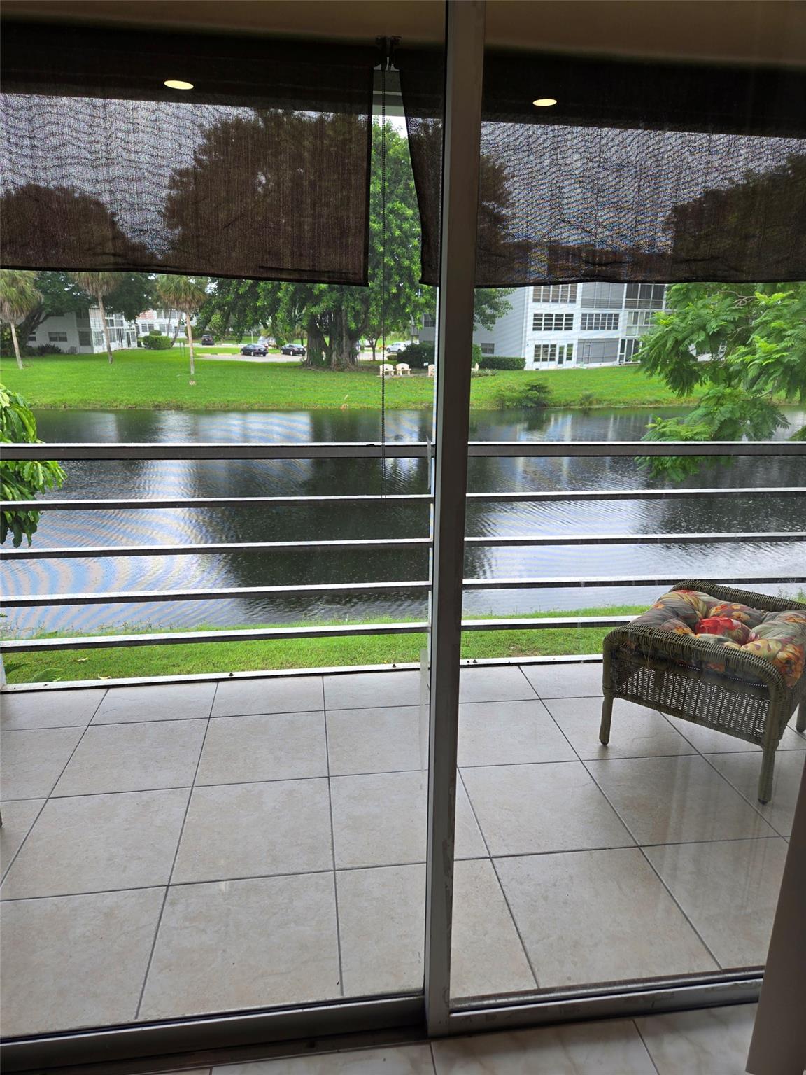 Light, bright, freshly painted ,corner 2bd 1 1 1/2 bath w/serene water view, some updates including tiled floors with new tiles in the second bedroom and updated bathroom .  A great Value for the price. HOA includes water, cable, and outside building maintenance. The main clubhouse has indoor and outdoor pool, restaurant, theater, clubs, classes, billiards, tennis, pickleball, volleyball, ping pong, shuffle board, fitness center, bike trails and more. Close to Beaches, Entertainment, Dining, Shopping.
