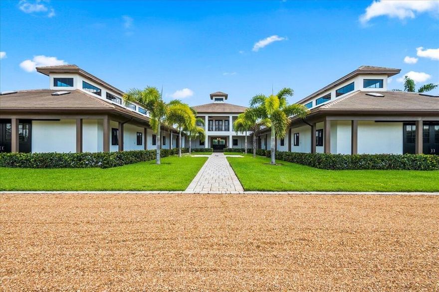 Luxury equestrian lifestyle beckons. This private gated farm is nestled in the the prime location of The Equestrian Club. Every feature of the custom built 18 stall barn reveals spectacular attention to detail. The barn has gorgeous cypress wood beamed ceilings with light filled cupolas and offers 2 aisles, each side mirroring the other. Thoughtfully constructed, both sides of this hurricane impact rated barn include new stall mats, an updated tack room, lounge/office with half bathroom, 2 wash stalls, 2 grooming stalls, a feed room, and a laundry room. Your horses will adore the brand new HSPG outdoor arena currently underway and 3 paddocks. The exquisite 3 bedroom, 3 bathroom owners residence is situated above the barn, is bathed in natural light,