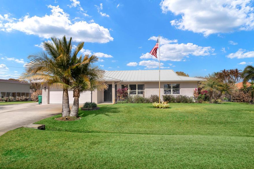 Welcome to this beautifully updated 3-bedroom, 2-bath home in the highly desirable Sandpiper Bay area of Port St. Lucie. Offering over 2,000 square feet of interior living space, this home features a spacious open floor plan designed for comfortable everyday living and easy entertaining. The interior has been completely refreshed with all-new luxury vinyl flooring and baseboards throughout, creating a clean, modern feel from room to room. The kitchen features granite countertops, stainless steel appliances, and a tile backsplash, blending style and function at the heart of the home. Step outside to enjoy the large covered back patio overlooking a newly fenced backyard with fresh landscaping — perfect for relaxing evenings, pets, or gatherings with family and friends. The property also includes a 2-car garage, dedicated RV pad, and a durable metal roof installed in 2015. Major updates provide peace of mind, including a new electrical panel (2024), generator hookup plug, irrigation pump (2024), water heater (2019), and AC system (2017). This move-in ready home combines space, updates, and an unbeatable location in one of Port St. Lucie's most established neighborhoods.