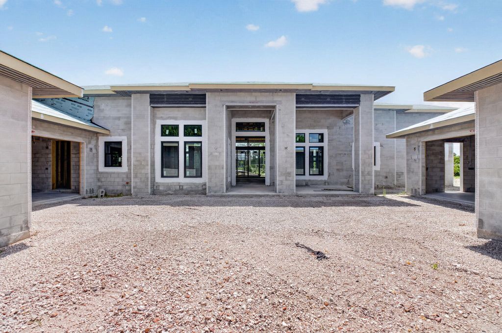 Photo of 6450 Sugarcane Lane, Lake Worth, FL 33449 (MLS # B26042499)