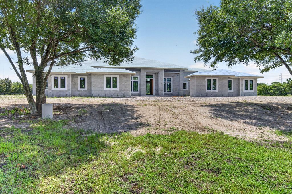 Photo of 6450 Sugarcane Lane, Lake Worth, FL 33449 (MLS # B26042499)