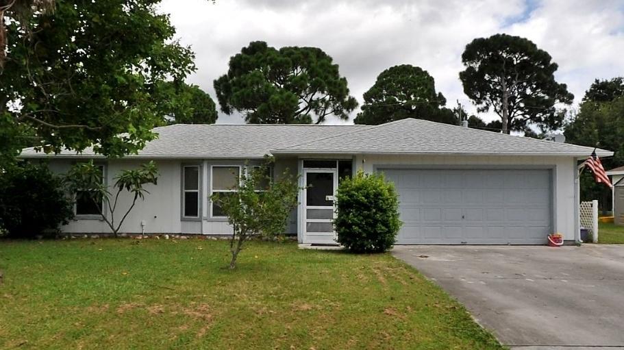 3/2/2 East of US1, walking distance to Mariposa Elementary! Tile throughout, split bedroom plan, updated bath & walk in closet in main bedroom, Screened patio overlooking spacious yard with oak tree