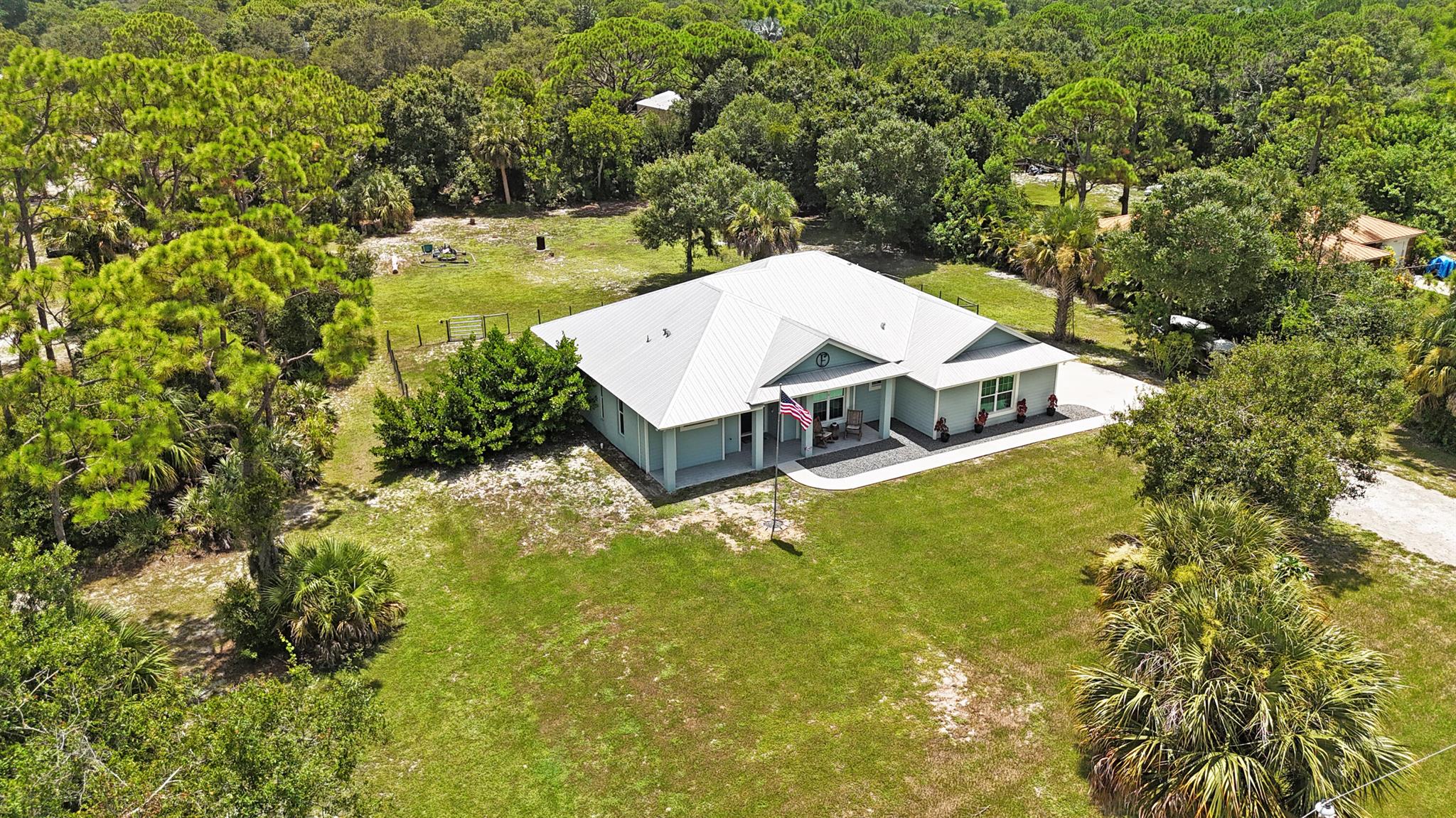 Modern luxury meets peaceful privacy in this 2019-built country dream nestled on 1.36 acres. Located in the sought-after, county tax-only neighborhood of Indian River Estates. This rare find offers the best of both worlds--contemporary finishes and newer construction paired with the space and freedom that only oversized land can provide. Inside, enjoy stylish modern touches, energy-efficient materials, impact glass windows & doors and open-concept living designed for comfort and connection. Step outside to your expansive property--perfect for storing toys w/ plenty of room to roam. Fenced backyard for the dogs & RV electric in the back. All this just minutes from the beach and quick highway access for seamless commuting. If you're looking for modern living with breathing room, this is it.