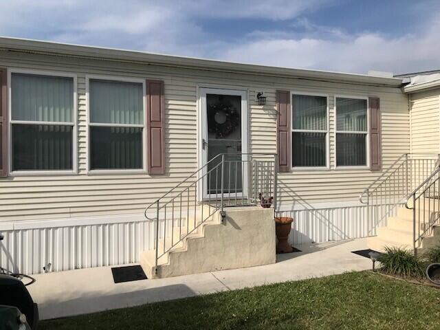 Beautiful well maintained 3 bedroom 2 bath manufactured home in Spanish Lakes Community with lake views. Custom Palm Harbor Model built in 2005 located at the end of a cul-de-sac. Home is 1,853 sqft of living with a den that could be a fourth bedroom with a separate entrance. Home features include drywall finish with extra insulation between walls and floor. Wood laminate floors in the family room, dining room and den. Title in kitchen and bathrooms. Island in kitchen with corian sink. Master suite has separate shower and jacuzzi tub. Family room has a wood burning fireplace. All stainless steel appliances and upgraded Cherry cabinets. Laundry room inside with large pantry. Brand new water heater, Brand New A/C unit and Home has 6 solar tubes for nature light throughout the home.