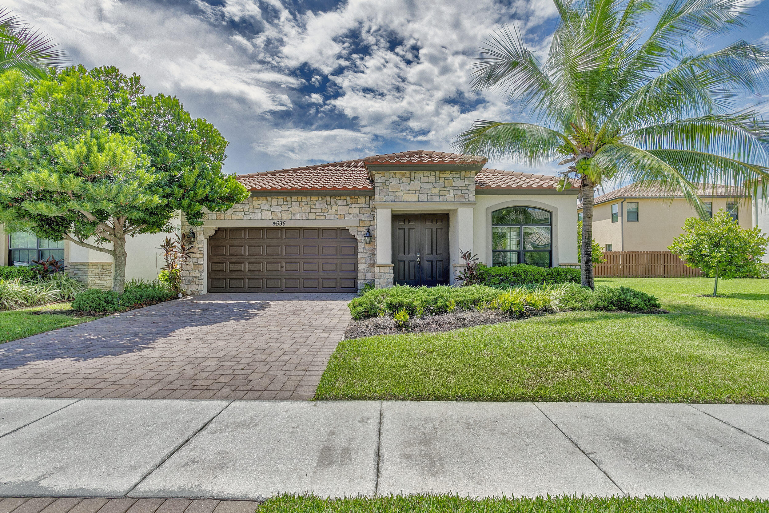 Fabulous single-story home in a gated, family-friendly community! Perfectly located near Wellington Green Mall, fine dining, and with quick access to Florida's Turnpike. Zoned for excellent schools, this residence offers both convenience and lifestyle. Step inside to soaring 9-foot ceilings in the spacious Living and Family Room areas. The light and bright kitchen is designed for both function and style, seamless connection to the covered terrace--ideal for indoor-outdoor living. The primary Suite is a true retreat, complete with a vast walk-in closet and a bath with a Roman tub and dual vanities. Light-filled interiors create a warm, airy atmosphere throughout, while maintaining a cozy feel. Community pool and playground. HOA requires min Credit 720 for all occupants over age 18.