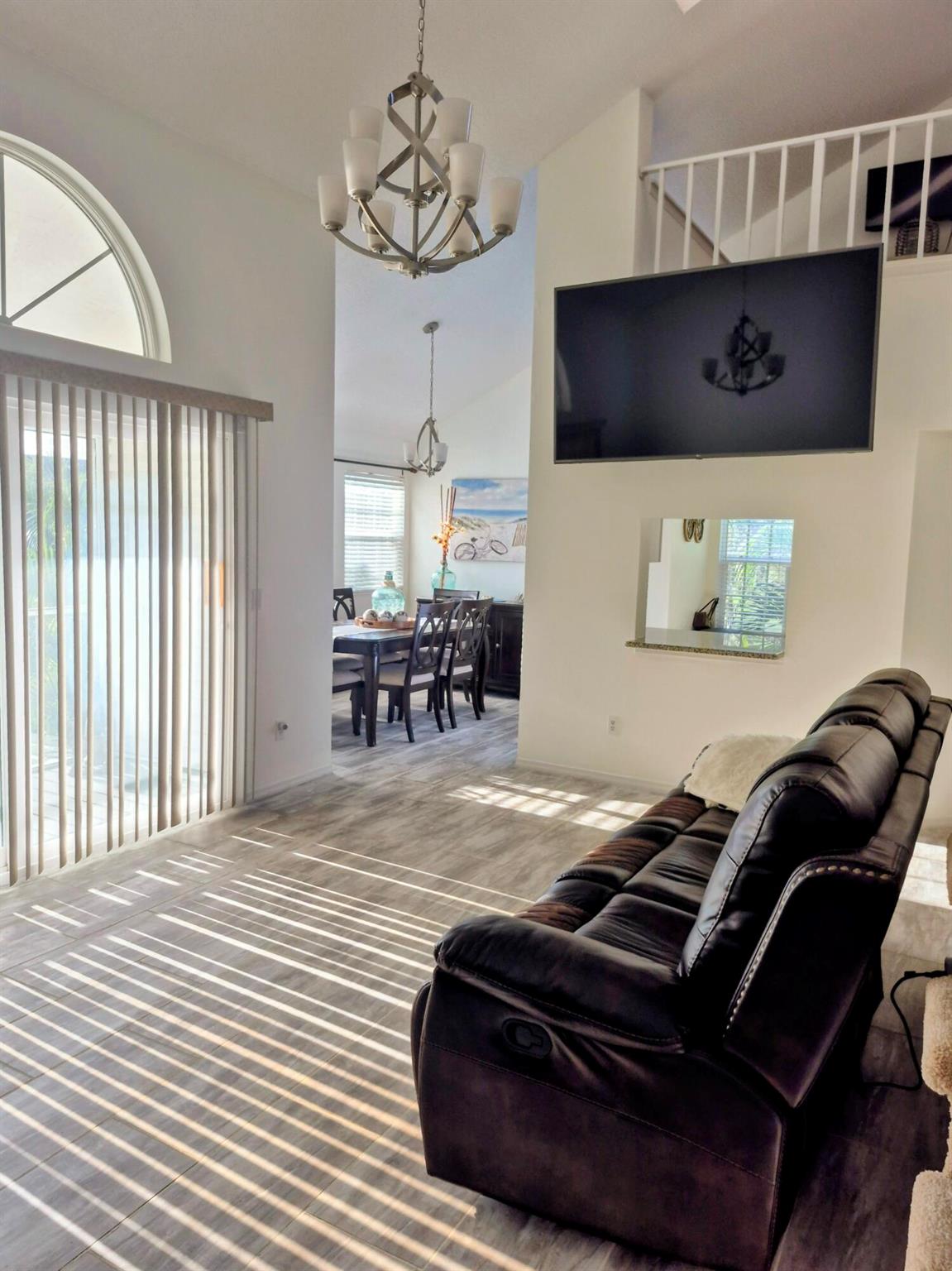Fully furnished and turnkey, this beautifully updated 3-bedroom, 3-bath home offers quality furnishings and modern upgrades throughout. The remodeled kitchen features a convenient pass-through window and full-house water filtration with reverse osmosis. Enjoy impact windows and doors, a separate dining room, and an open living area ideal for entertaining. The spacious loft includes a full bathroom, perfect for guests or a home office. Additional highlights include an in-unit laundry room with washer and dryer, and a private balcony offering peaceful lake views. NO PETS-Only ESA or certified service animals are permitted by the Lake in the Woods Association. Large dogs are prohibited by the HOA unless certified as service animals. Community amenities include a clubhouse, pool, fitness cent