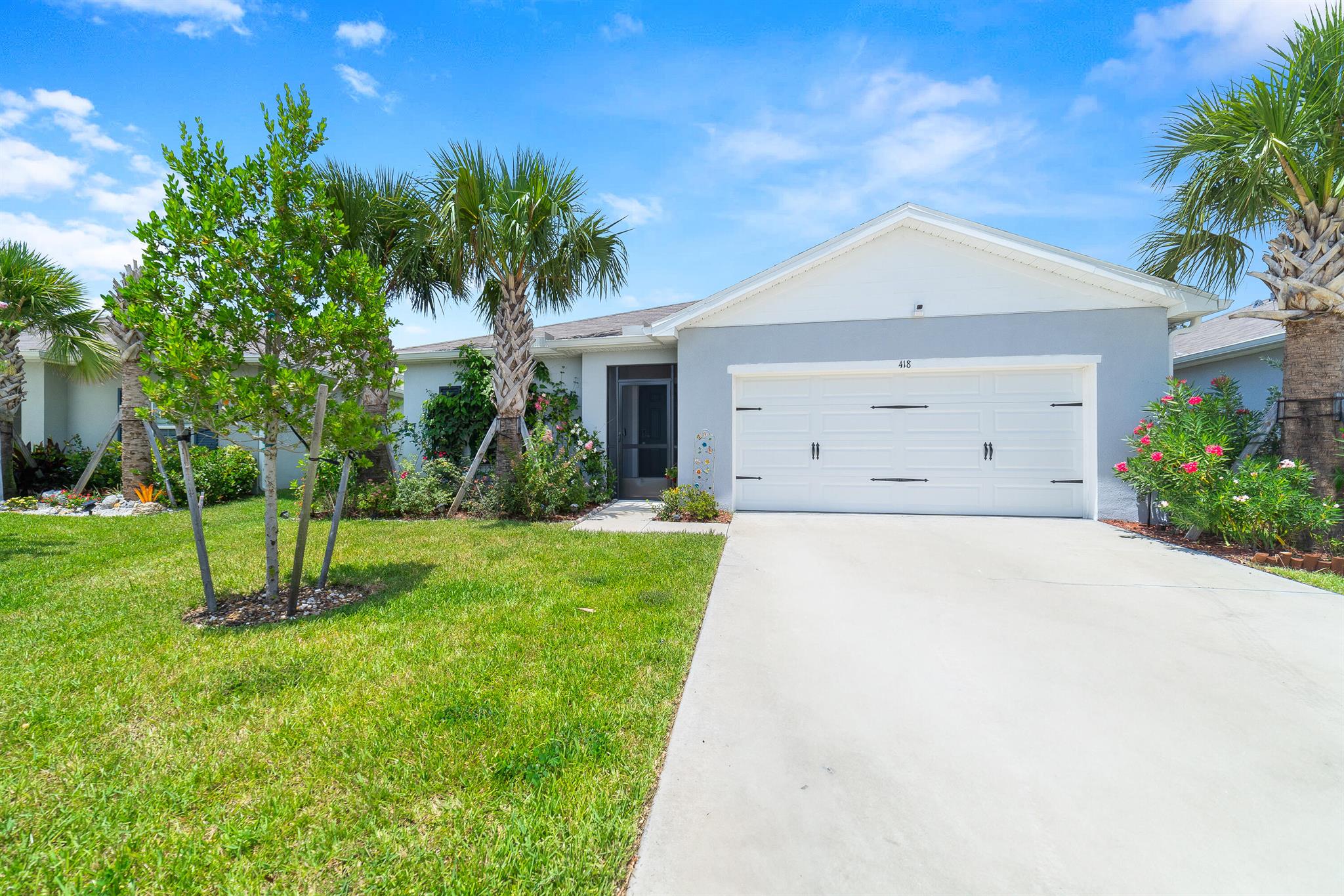 Welcome home to this like new opportunity located in the highly sought after Avalon Crossing of Fort Pierce. Built in 2023, all major systems and appliances are in like new condition. As soon as you enter, you immediately notice the natural light and view to the expansive backyard. The home features tile flooring throughout the living areas with carpeting in the bedrooms. The kitchen boasts granite countertops, stainless steel appliances, large pantry and huge breakfast bar leading out to the family room, perfect for entertaining. The primary bedroom offers tons of room, walk in closet and en suite bath with dual sinks. The secondary bedrooms provide ample space as well with a triple split bedroom floorplan for added privacy and convenience. As you head out back, you have tons of