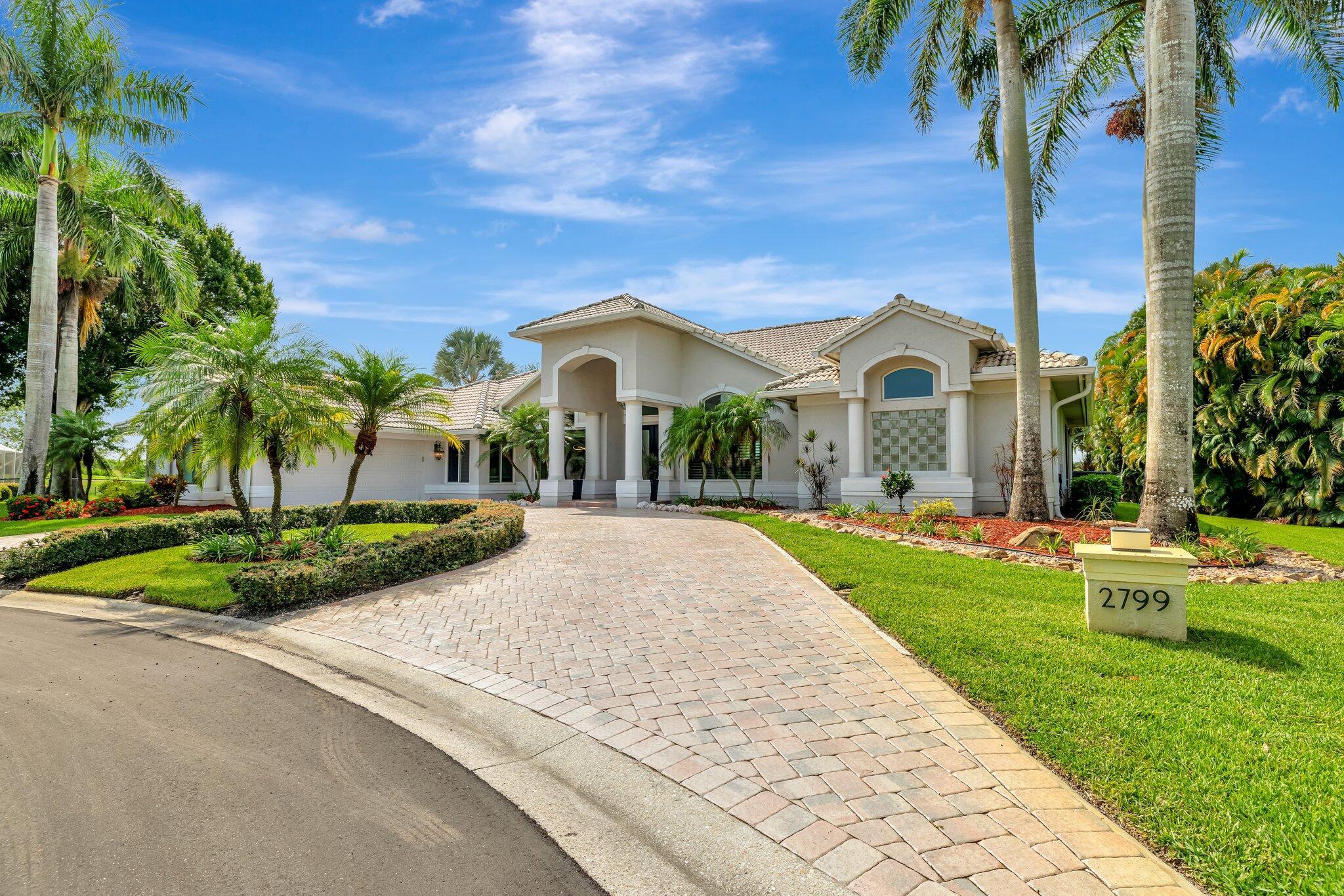 Welcome to your Private Oasis! This 3,419 sq ft, 3-bed + den/office, 3-bath, 2-car garage pool home is perfectly situated on a 1/2 acre cul-de-sac lot with a lake on one side and a wide fairway of The Saints Golf Course behind. Light-filled and spacious, the home features an open kitchen, dining, and family room ideal for entertaining. The private primary suite is separated from guest rooms. Outside, enjoy the beautiful pebble tech finished pool, outdoor kitchen, and large lanai with hurricane reinforcements. Bonus: a separate workshop for all your hobbies! And additional features including epoxy garage floor, impact windows/doors, Generac generator, buried propane tank, well-fed sprinklers, and circular drive--all near shopping and beaches. Come fall in love with this home!