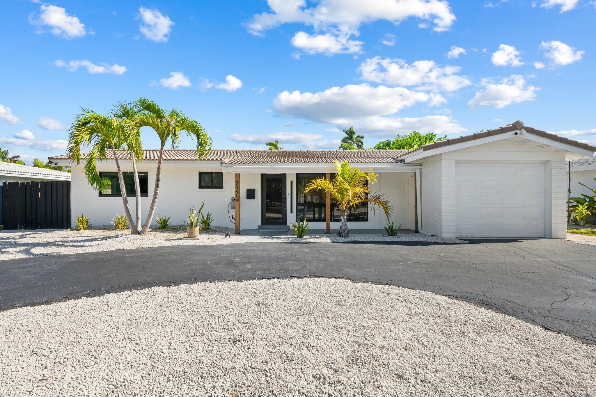 Just 5 minutes to the beach! Fully renovated 2 bedroom, 2 bath home with high-end furnishings, garage & sparkling saltwater pool with jets. Modern upgrades include impact windows & doors, hardwood flooring, fresh paint, updated electrical panels & Lutron smart lighting for a sleek style. Featuring a bright open layout & separate laundry/office space. Relax in a screened patio overlooking a maintenance-free fully fenced yard with brand new turf lawn ideal for gatherings. A wrap-around driveway adds convenience. ADT security system with cameras for peace of mind. Prime location near Lauderdale-by-the-Sea, Pompano Beach Pier, dining, shopping, nightlife, parks & major highways. Minutes to some of the best private schools & everyday conveniences. Private oasis with a vibrant coastal lifestyle!