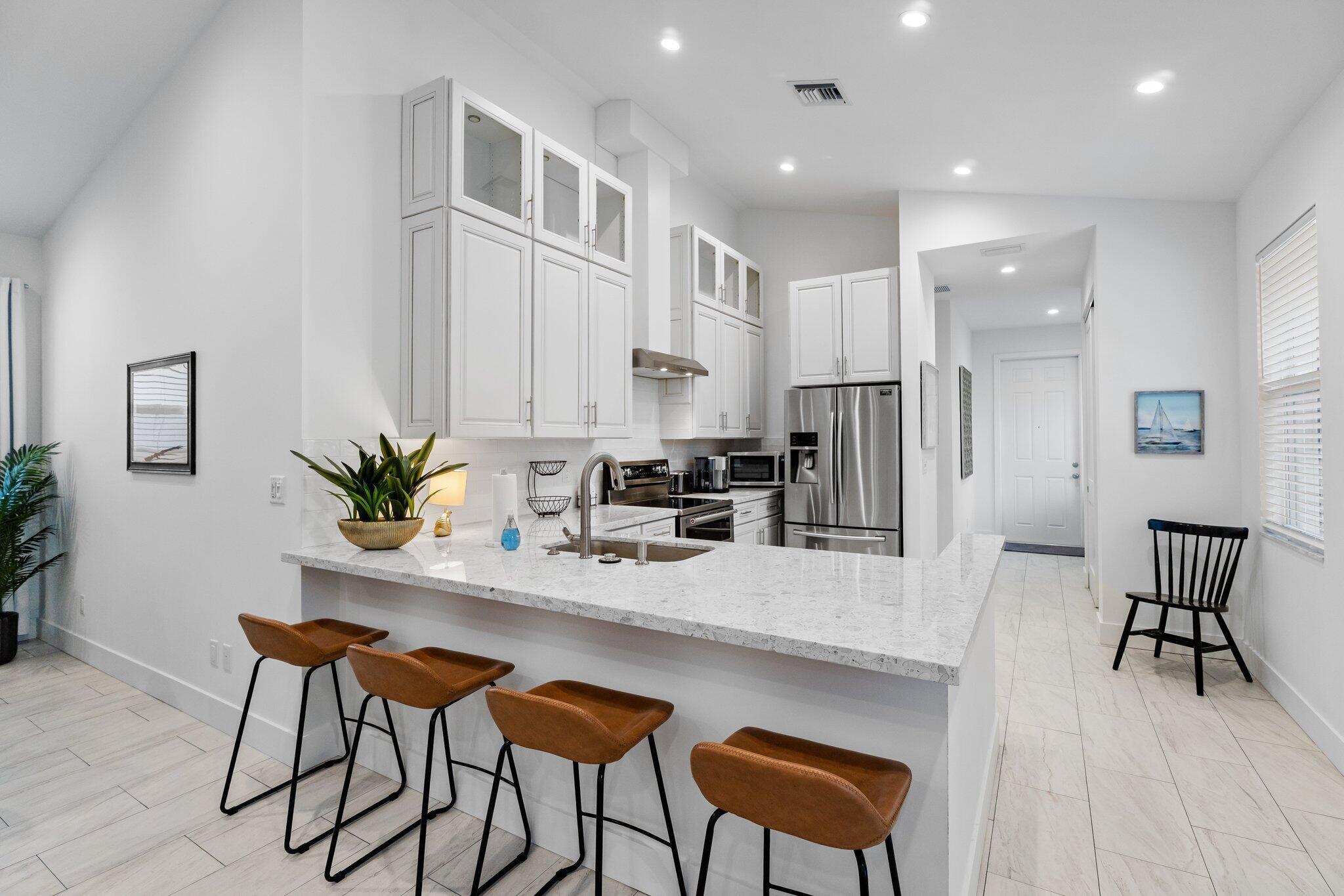 Your brand new, turn-key, furnished, seasonal 2025/2026 rental awaits! Never occupied and decorator finished, this three bedroom, two bath unit with 1,500 square feet lives like a single family home. Cathedral living space and split floor plan to accommodate everyone and still maintain privacy. Full size washer dryer and plenty of parking. Close to shopping, dining and minutes to the beach and I-95. Minimum 3 month rental period. Start living the south Florida season today!