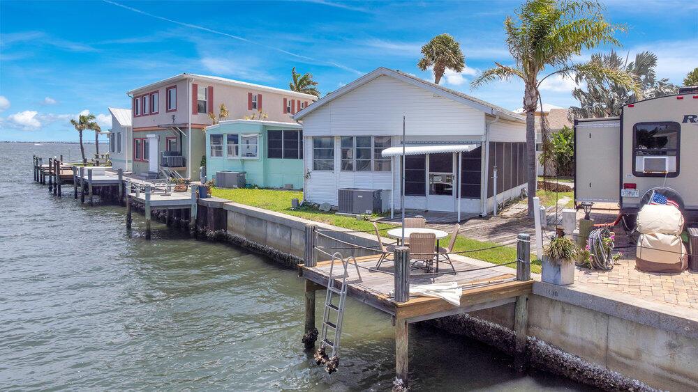 Welcome to paradise! Located in the coveted guard-gated Nettles Island on Hutchinson Island, this charming 2/1 waterfront home sits just four doors from the Indian River. Ideal for short-term rentals or for anyone seeking the ultimate beach lifestyle. Sip your morning coffee from the sunroom or dock as dolphins pass by. Enjoy resort-style amenities including private beach access, two heated pools (ocean & riverside), tennis, pickleball, mini golf, and more.Whether you choose to renovate or rebuild, the potential is endless. Don't miss the chance to own a piece of Florida's best-kept secret!