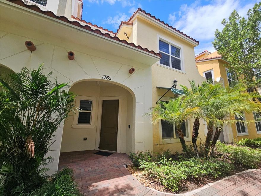 Lightly used as a vacation retreat, this model-home-style 3-bedroom, 2.5-bath townhouse with a 2-car garage is set within an upscale Mediterranean-inspired community that blends style and comfort. The home offers quartz countertops, stainless steel appliances, and an upstairs enclosed laundry room with washer and dryer for added convenience. Hurricane-impact windows and doors provide enhanced safety. Bright, open living spaces showcase abundant natural light and contemporary finishes throughout. Guest half-bathroom downstairs. Residents enjoy a resort-style pool and a fully equipped fitness center. Ideally situated near shopping, dining, and top-rated schools, yet privately tucked away in a quiet setting, this property is perfect for a family or couple. Priced to sell and easy to show.