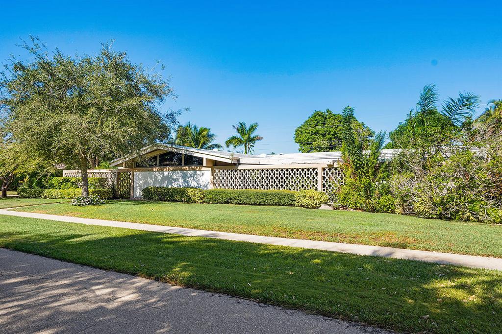 Prime land and home in East Boca Raton's Golden Triangle is minutes from the beach and moments from Mizner Park . This Magnificent Mid Century Modern Home is ready for you to make your own or build the home of your dreams. This property is located on an over sized Lot (150 Feet x 106 Feet). Very quiet and private street. NO HOA.