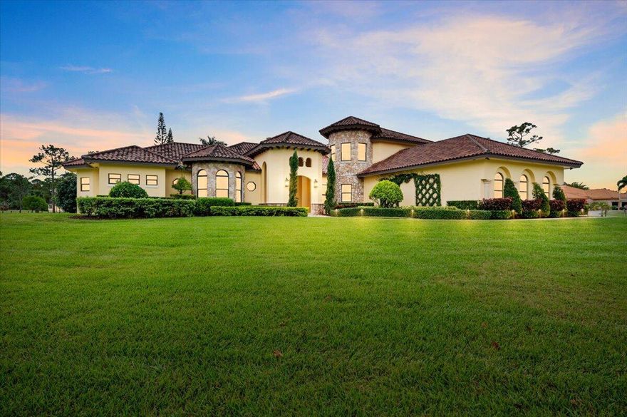 Nestled in a serene gated community, this custom 4-bed/5.1-bath, 9+ car Tuscan estate embodies luxury. Meticulously maintained, it features hurricane impact windows, a whole house generator, safe gun room holds 100+ guns, and a detached 2400 square foot garage for 6+ cars. Enjoy a custom pool, firepit, home theatre, and office space. Conveniently located near major highways, golf courses, and the airport, this equestrian community offers a blend of tranquility and accessibility. A rare opportunity for sophisticated living, combining comfort, security, and entertainment in a peaceful setting.  Tiny House available outside of the sale. See more...