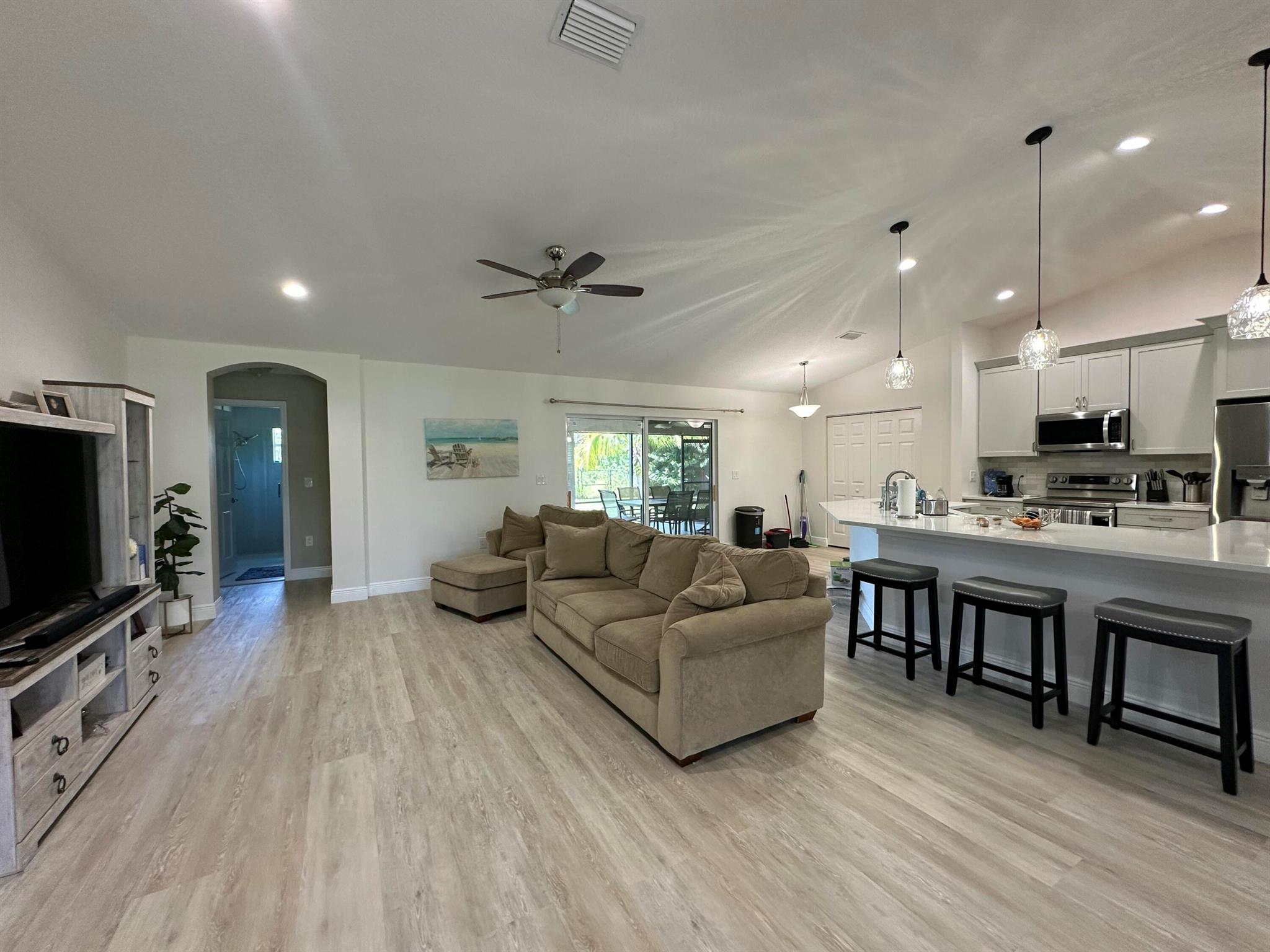 Beautifully renovated 4-bedroom, 3-bath rental home featuring luxury vinyl plank flooring, quartz countertops, and stainless steel appliances. The open-concept layout includes a modern kitchen with ample cabinetry and a large island, seamlessly flowing into bright living and dining areas. All bedrooms are spacious, with updated bathrooms throughout. The primary suite offers a generous open closet. Stylish, durable finishes make this home the perfect blend of comfort and modern living.