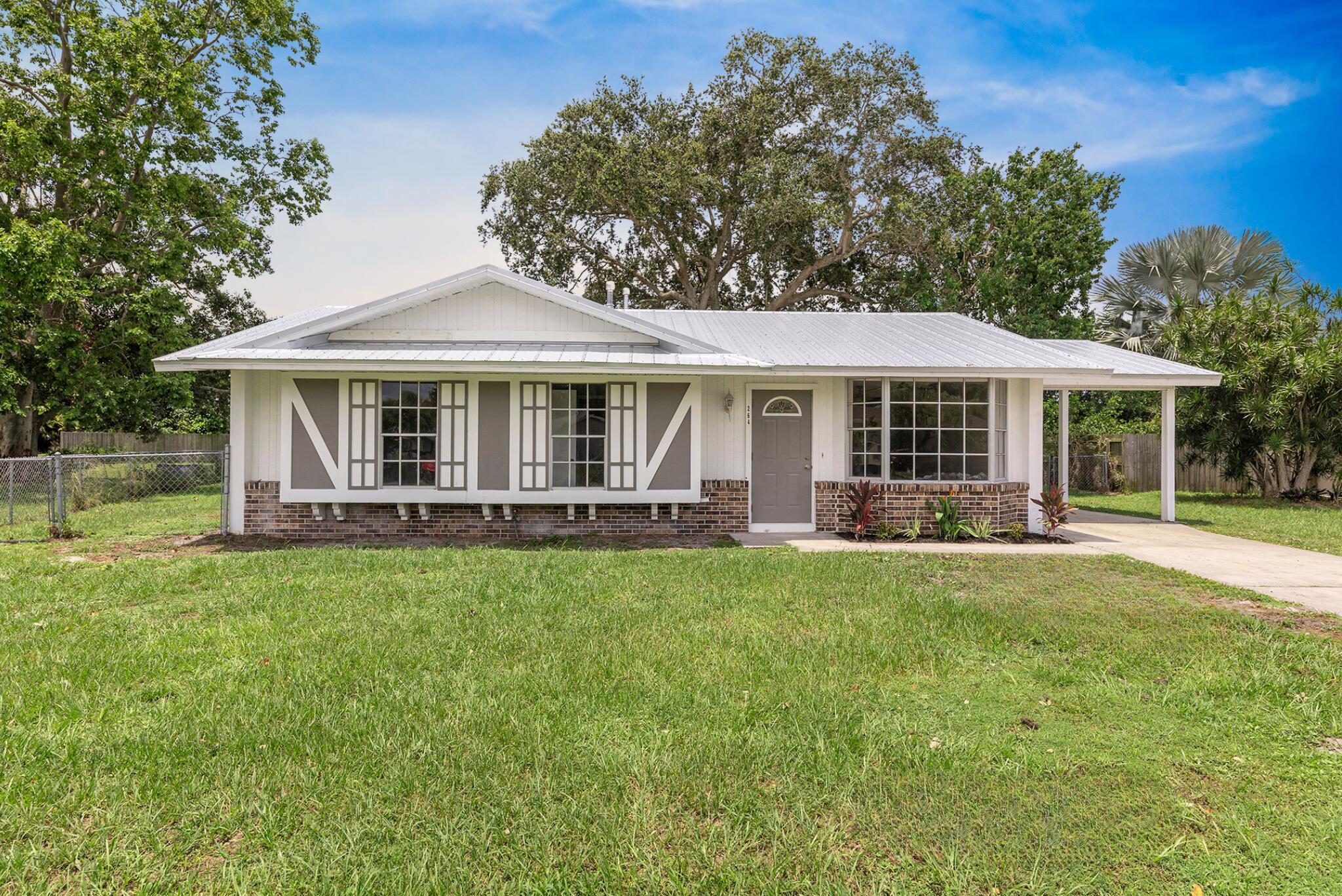 NEW METAL ROOF! NEW AC! NO HOA! COMPLETELY REMODELED! Fully remodeled from top to bottom, this 3-bed, 2-bath CBS home in the heart of Port St. Lucie is move-in ready and beautifully updated. Enjoy a brand-new kitchen with quartz counters, black stainless steel appliances, and stylish modern finishes throughout. Both bathrooms have been completely renovated with modern tile, vanities, and fixtures. The home features wood-look flooring, updated lighting, fresh paint, and a spacious bonus room perfect for a home office or den. Major upgrades include a new roof, new HVAC, new water heater. Outside, you'll find a large fenced yard, storage shed, and covered carport. Conveniently located near schools, parks, and major roadways such as Crosstown and US-1! Schedule your showing today!