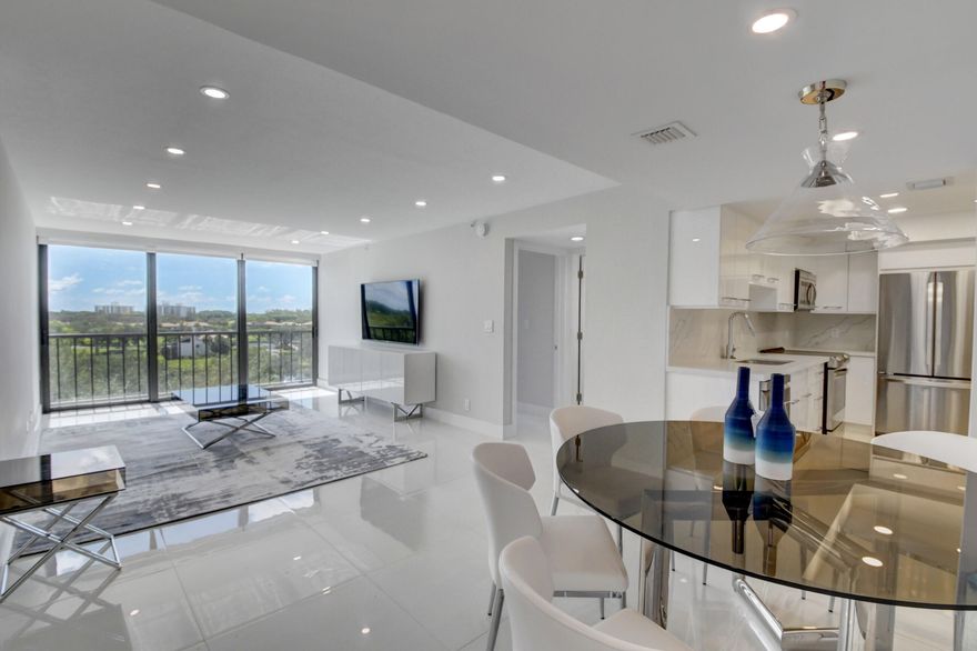 This expanded 2-bedroom, 2-bathroom Lakewood condo was renovated to the highest degree!! With a great treetop view from the 6th floor, this condo offers 1,210 sq ft due to an enclosed terrace with sliding impact glass, full-size washer/dryer, finest finishings and elegant tile floor in all rooms. Designer Furnishings included!! In #1 residential Boca West Country Club a stunningly renovated. Get your place and move in and ENJOY from DAY 1!  Close ASAP to avoid increase in Boca West initiation fees going up $75,000 on Oct. 1, 2026.