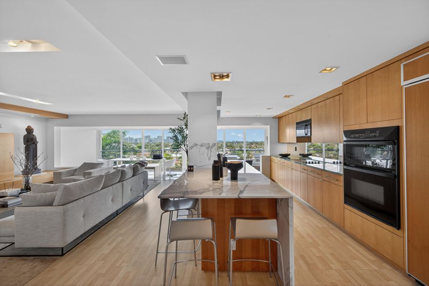 Renovated Penthouse with custom finishes and AMAZING views of exclusive Coral Ridge neighborhood, canals leading to the Ocean and downtown Fort Lauderdale skyline! Spacious floor plan offering open kitchen with Italian marble countertops, KitchenAid applicances, including glass cooktop. Custom built-in cabinets with 15 ft island and 20 ft of back cabinet space! A chef's dream. Whirlpool front load washer and dryer in laundry room behind a custom wall paneling with blind door. Both bathrooms have also been renovated and have Italian porcelain slabs on floors and walls, plus custom vanity and medicine chests with integrated outlets. Motorized blinds in both spacious bedrooms. Custom built-in closets. Custom lighting throughout, HIGH impact windows and 30 ft of IMPACT sliding glass doors!