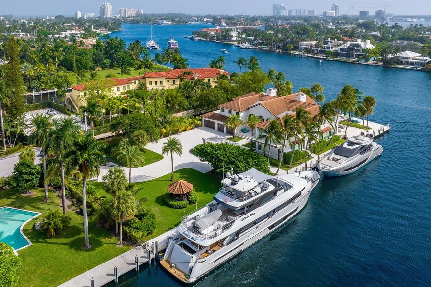 MAJOR PRICE IMPROVEMENT!! This timeless peninsula estate offers one acre of land on the New River with 700’ of deepwater frontage, accommodating multiple large yachts without obstructing views. Interiors by Katia Bates showcase custom finishes, expansive living areas, and covered entertaining spaces. The dual chef’s kitchen is paired with a catering kitchen, while the 3,000 SF primary suite wing features sweeping balcony views, very large closets, and a spacious his and hers bath. Car collectors will value the garage holding up to 12 cars with lifts. This resort-style estate includes nightly patrol, smart-home security, and new underground utilities. Another structure, such as a guest house can be built on the property. The home is just minutes to the ocean and private airports.
