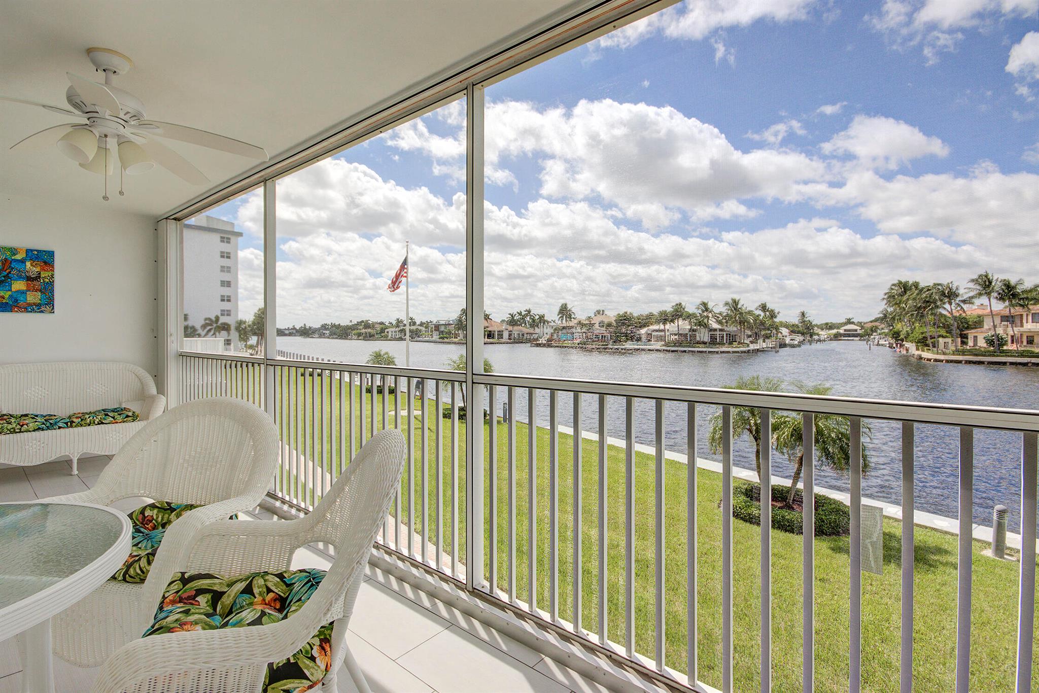 Escape to this bright, beautiful, and fully appointed waterfront condo--your perfect seasonal retreat.The open-concept living area offers comfortable seating and a serene, coastal-inspired decor with blue accents, leading to a balcony with stunning canal views. The elegant dining area is set beneath a tiered crystal chandelier, featuring a modern white table and a dramatic mirrored wall that enhances the light and space. The adjacent galley kitchen boasts chic white cabinetry, stainless steel appliances, and a striking navy blue tiled backsplash contrasted by blue-gray countertops.This condo offers a clean, sophisticated, and efficient base for an ideal Florida getaway. Enjoy the best of the waterfront lifestyle with the added convenience of a carport.