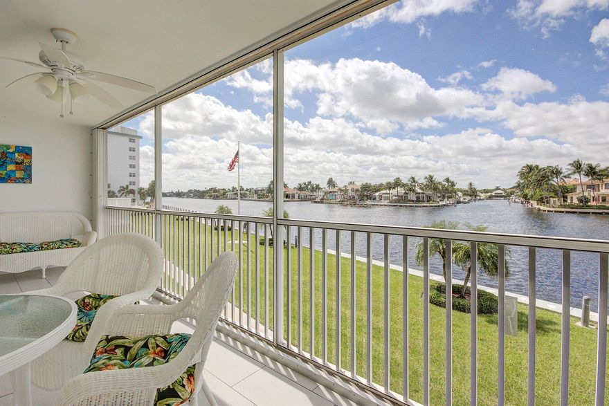 Escape to this bright, beautiful, and fully appointed waterfront condo--your perfect seasonal retreat.The open-concept living area offers comfortable seating and a serene, coastal-inspired decor with blue accents, leading to a balcony with stunning canal views. The elegant dining area is set beneath a tiered crystal chandelier, featuring a modern white table and a dramatic mirrored wall that enhances the light and space. The adjacent galley kitchen boasts chic white cabinetry, stainless steel appliances, and a striking navy blue tiled backsplash contrasted by blue-gray countertops.This condo offers a clean, sophisticated, and efficient base for an ideal Florida getaway. Enjoy the best of the waterfront lifestyle with the added convenience of a carport.