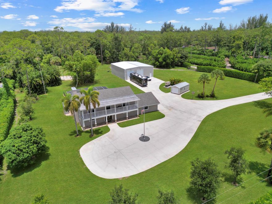 Private 5-acre paradise in Loxahatchee Groves, this custom 4BD/3.5BA pool home boasts over 3,300 sq ft of luxurious living with a chef's kitchen (dual ovens, hibachi island), steam shower in the primary suite, and balconies for sunrise & sunset views. Entertain effortlessly indoors and out with a large living room, fireplace, screened patio, and sparkling pool. The massive 5060 detached garage is ideal for RVs, business equipment, or hobbyists. Zoned Agricultural-Residential with NO HOA--bring your horses, toys, or big ideas. Mature trees, RV hookup, whole house generator, and 3-phase power. Peaceful country living just minutes from Royal Palm amenities and the Turnpike!