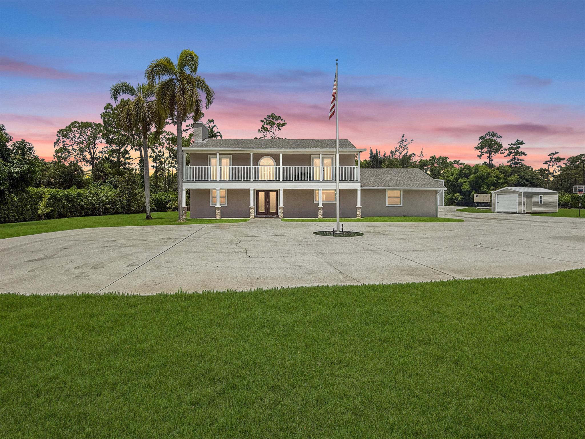 Private 5-acre paradise in Loxahatchee Groves, this custom 4BD/3.5BA pool home boasts over 3,300 sq ft of luxurious living with a chef's kitchen (dual ovens, hibachi island), steam shower in the primary suite, and balconies for sunrise & sunset views. Entertain effortlessly indoors and out with a large living room, fireplace, screened patio, and sparkling pool. The massive 5060 detached garage is ideal for RVs, business equipment, or hobbyists. Zoned Agricultural-Residential with NO HOA--bring your horses, toys, or big ideas. Mature trees, RV hookup, whole house generator, and 3-phase power. Peaceful country living just minutes from Royal Palm amenities and the Turnpike!