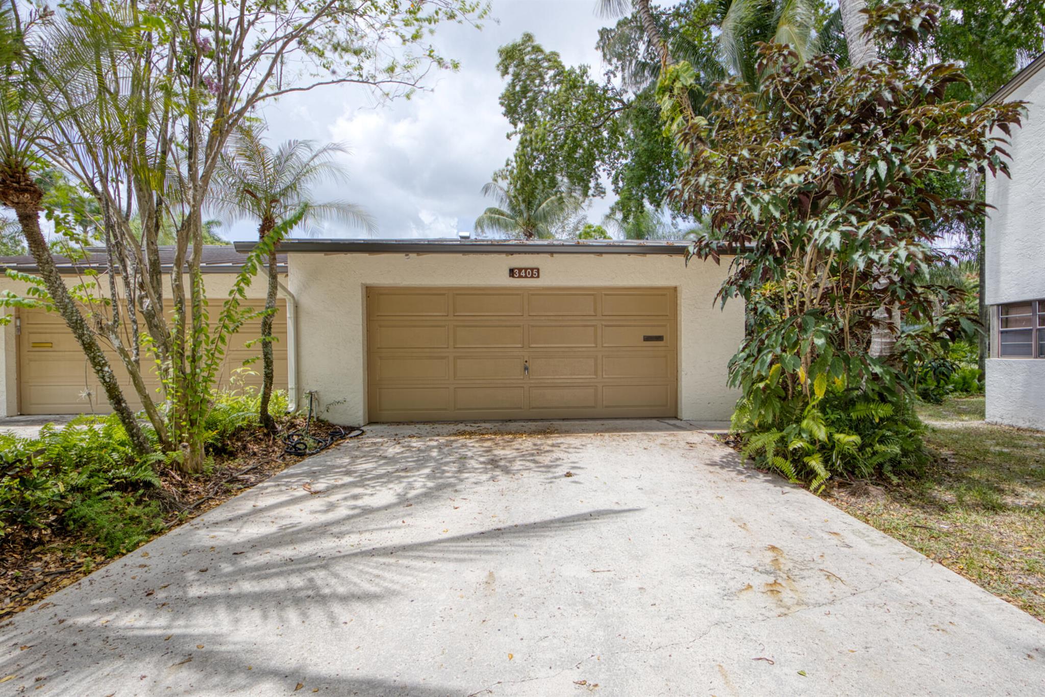 Tranquil and private with lush and tropical landscaping. Living area downstairs, and bedrooms upstairs. Nice and private patio outside of living room. Large two car garage. Newer appliances appliances, freshly painted and A/C within the last 5 years. Most of the home has been remodeled in the last year and very little use. Quiet and safe neighborhood. Short walk to the heated pool along a path surrounded by big trees and green grass. Just bring your clothes and everything else will be ready for you. This Property has a brand new metal roof in stalled May of 2024!
