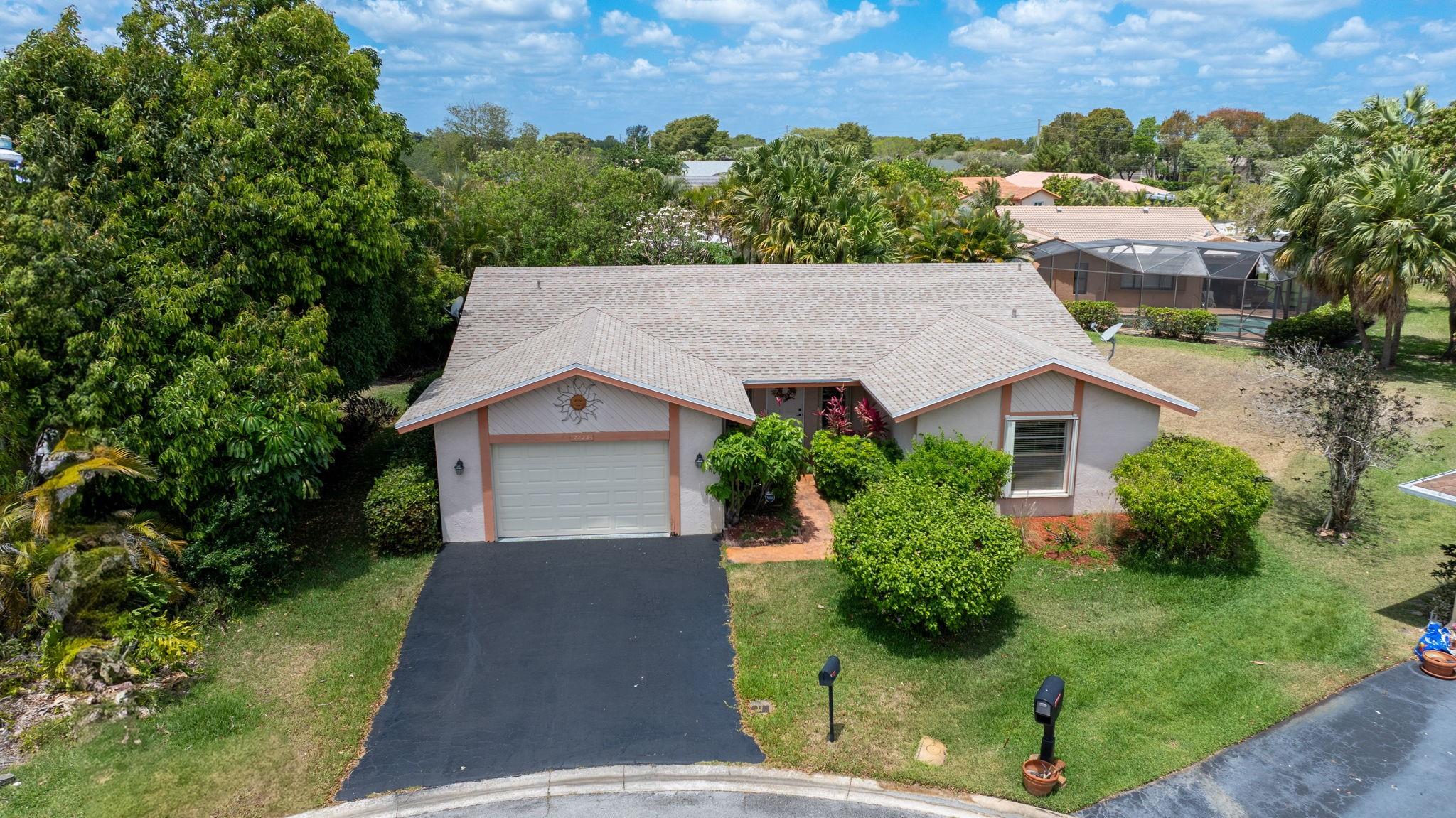 Looking for a spacious home with vaulted ceilings & a modern, open floor-plan in Isles of Tamarac? With 2044 square feet of living area-the possibilities are endless! The super-sized living room & formal dining room opens into the family room with plenty of space for casual dining & leading onto the covered, screened patio. Very serene-peaceful setting to enjoy nature! Accordion Shutters, Impact Doors, New Roof & AC 2024 make this a sound investment. The primary bedroom suite has a walk-in closet & lovely bathroom with dressing vanity-very spacious. The second bedroom easily accommodates a king-sized bedroom set! One and a half car garage-plenty of storage! Oversized, private lot, cul-de-sac street. Large pets allowed. HOA-clubhouse, pool, tennis & pickleball courts only $30 a month! WOW!
