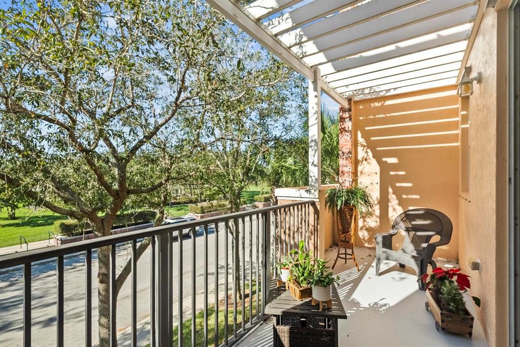 Perfect for every season! Beautiful sunsets from 2 private balconies overlooking the tree landscaping and park area. Like new 2-bed, 2-bath condo +den in The Promenade at Tradition. Walkable distance to many shoppes, restaurants, and town events. Wood flooring, crown molding, high ceilings, and taller interior door height. Stainless steel appliances and granite countertops in kitchen. Washer and dryer included in the laundry room inside. Extended garage length with extra storage closet. Community has resort-style pool, dog park, kids' playground, and picnic area. Excellent schools nearby. Close to I-95 and the Hospital.