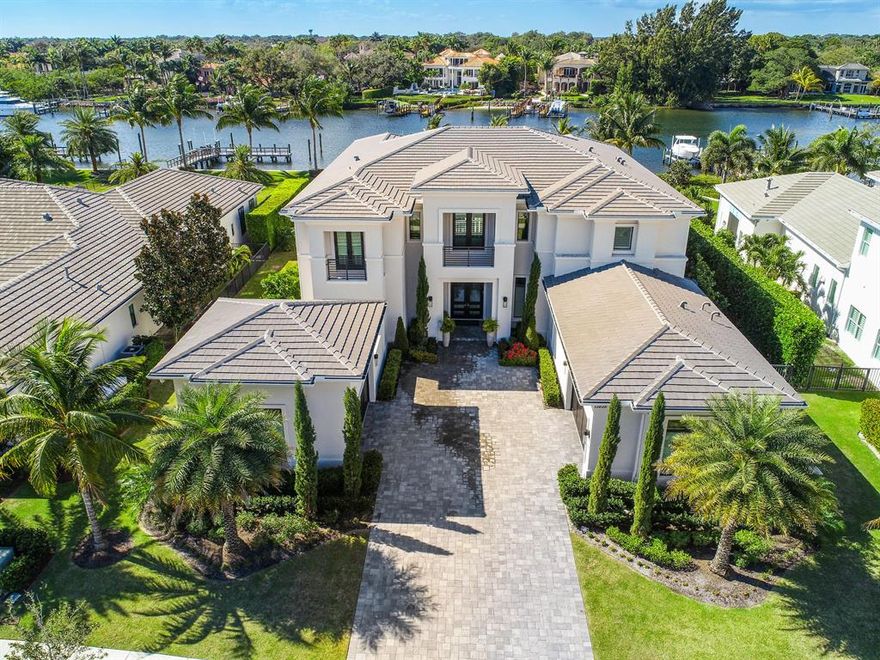 An Immaculate Luxury Estate home with over 100' of Direct Intracoastal Waterfrontage and Private Dock! A boater's dream, this oversized waterfront lot comes equipped with a 45' dock that can house up to a 70' vessel and boasts a 38k pound lift in a No Wake Zone. Newly constructed and customized, this coastal transitional estate home was built with full two-story CBS construction, no expenses spared and is fully upgraded. Located in the exclusive boating community of Frenchman's Harbor, this modern residence has 5 full bedrooms, 7 1/2 baths, a large upstairs bonus room, den/office, private elevator, extended loggia with outdoor kitchen, a heated saltwater pool/spa and 4-car garage.