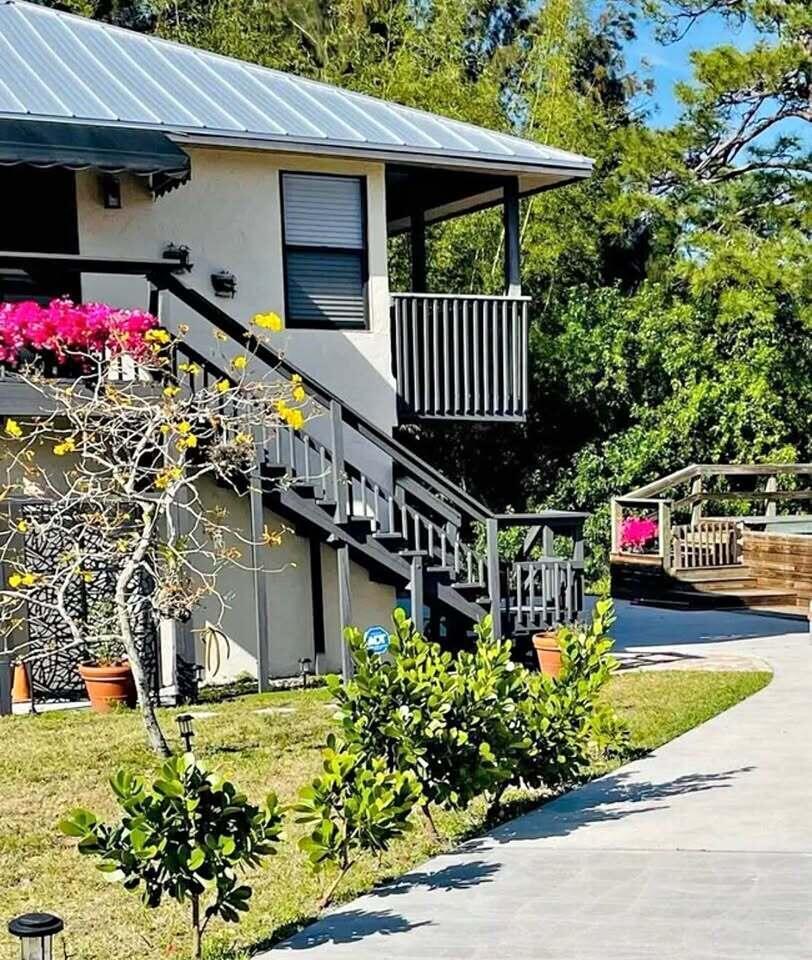 Your oasis awaits you! Mother-in-law building (top floor) on half an acre. Stunning and private!! Desirable location in Jensen Beach. Close to beaches and both downtowns. 2/1 furnished with brand new queen bed. 2nd room empty. Marble floors throughout and bedrooms with wood floors. Wrap around balcony overlooking lush landscape and bamboo. Crystal chandelier. Beautiful decor. High quality black out drapes. SS appliances, gas stove, hurricane impact windows and sliders. City water. No flood zone. Built like a bunker. No trucks. Small dog (10 pounds). Owner maintained property immaculately.