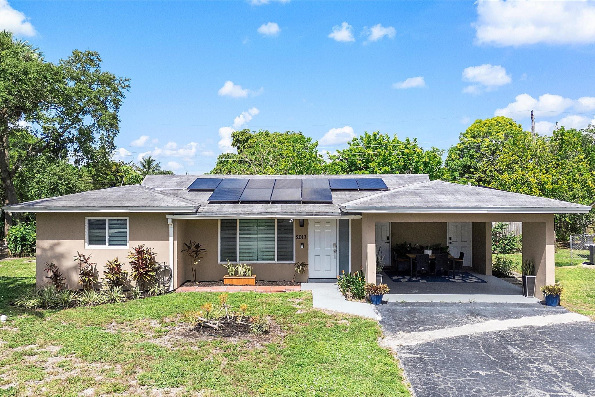 You'll be impressed by this attractive, fully updated Fort Lauderdale home near Wilton Manors, Oakland Park, and downtown Las Olas! Featuring fully paid-off solar panels (added in 2021), the average electric bill is just $30/month. Enjoy peace of mind with impact windows (2018), a new roof (2017), and HVAC system (2022). Inside, low-maintenance tile and vinyl flooring complement the bright white kitchen with stainless steel appliances and spacious living and dining areas—perfect for entertaining. The fenced backyard offers a patio and room for a pool, and the carport is perfect for one car but is currently styled as a charming shaded dining area. No HOA—pet-friendly with immediate rental potential. Schedule your tour today—this one won't last!