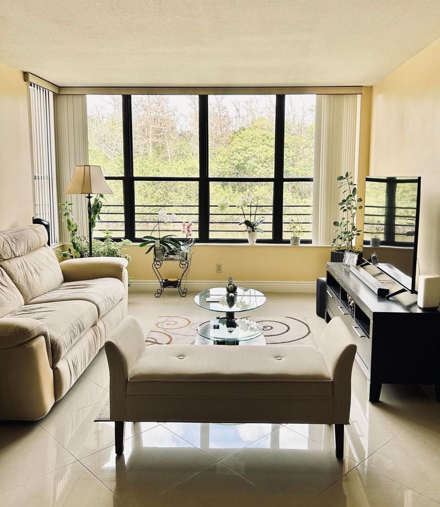 Discover the perfect blend of comfort and style in this beautifully maintained 2 bedroom, 2 bath condo. Step inside to a spacious layout featuring a large, upgraded kitchen with modern finishes, sleek tile flooring throughout, and the convenience of in unit laundry room. Accordion shutter on all windows and plenty of guest parking. AC replaced in 2018 and roof in 2024. Wake up each morning to stunning lake views and the soothing sights of the bird sanctuary right outside your window. The community offers  several amenities including pickleball, basketball and tennis courts, gym, olympic sized pool and more. Association maintains strong reserves and has already passed its structural inspection. Move in ready and thoughtfully updated, this unit is a rare find you won't want to miss.