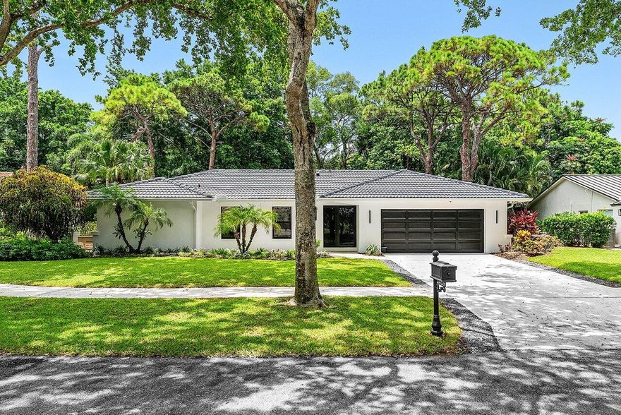 Stunning, renovated 4 BD, 2 BA home (plus den/office) in Millpond, where modern design meets warmth. Soaring cathedral ceilings and wide-set sliding doors create an airy, sun-filled atmosphere from the moment you enter. Lush views of the private backyard are enjoyed here, complete with a sparkling pool and vibrant tropical landscaping. The kitchen faces a wall of windows that invite in natural light, casting a warm glow over the stainless steel appliances, sleek finishes, and gas stove. The spacious primary suite features sliding doors to the pool, while the en-suite bath includes a stylish barn door entry, a soaking tub, and a large walk-in closet. A dedicated office with built-in cabinetry offers function and flexibility, and a cabana bath conveniently serves the hallway leading to 3 additional bedrooms. Step outside to a chic covered patio, where wood-paneled walls and ceiling details set the tone for elevated outdoor living. Outside, bar seating lines a set of windows that open directly to the kitchen, creating a seamless setup for serving and entertaining. The screened-in pool area provides year-round enjoyment protected from the heat and insects but open to the breeze. The screened-in pool area provides year-round enjoyment, and privacy landscaping is backed by a private walking path and park.