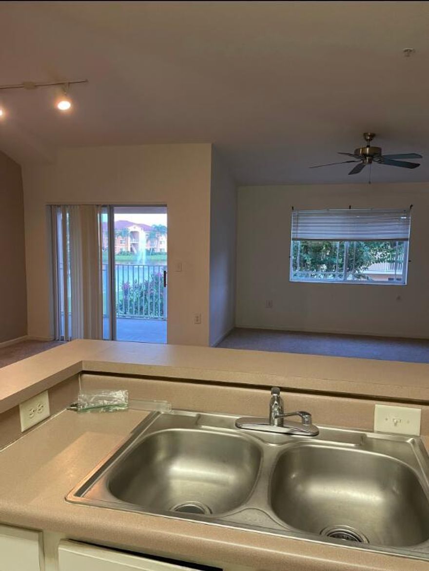 This charming second-floor corner unit offers stunning lake views, high vaulted ceilings, and beautiful laminate flooring--plus the added privacy of having no unit above. This one-bedroom, one-bath condo is located in the heart of Saint Lucie West, within walking distance to a variety of restaurants and shopping options. It also includes in-unit laundry for added convenience. The community features a range of amenities including a pool, gym, tennis court, picnic area, and playground, providing an exceptional lifestyle for residents.