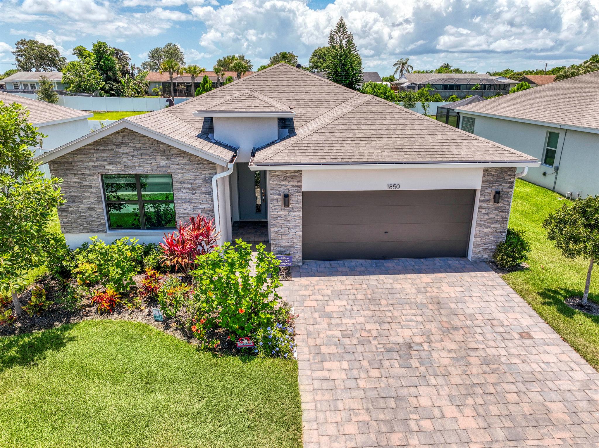 Welcome to Sabal Pointe! This stunning Delray model home offers 4 bedrooms, 2 bathrooms, and over 2,000 square feet of beautifully upgraded living space. Built in 2023, this modern residence features impact windows, quartz kitchen countertops, a stylish tile backsplash, durable tile flooring throughout, and elegantly tiled showers. As a resident of the Sabal Pointe community, you'll enjoy access to a resort-style pool and a prime location, just minutes from fine dining, boutique shopping, A+ rated schools, and the vibrant downtown area of Jensen Beach. Don't miss your opportunity to own this like-new home in one of the area's most desirable communities!